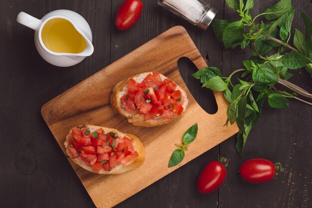 Appetizer bruschetta with tomatoes, olives and herbs. Italian cuisine