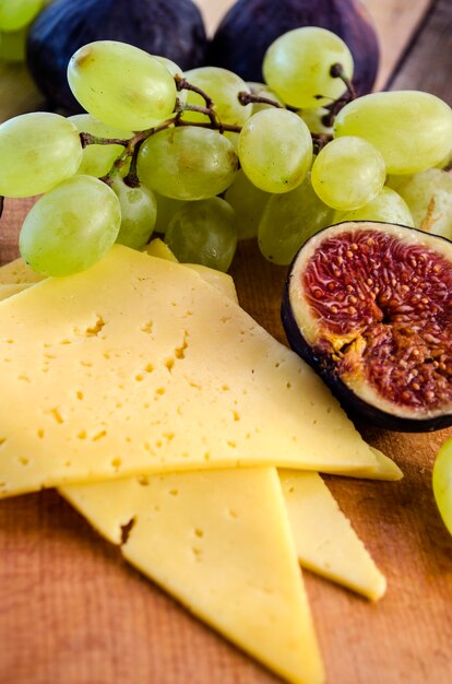 Appetizer of cheese with figs and grapes