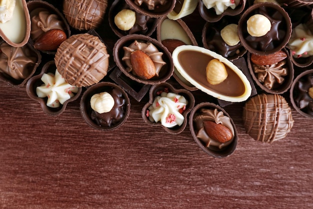 Appetizer chocolate candies on wooden background