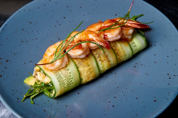 Appetizer of cucumber rolls with shrimp and cream cheese.