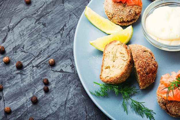 Appetizer homemade cod roe fish meatballs.Fish cutlets decorated with salmon.