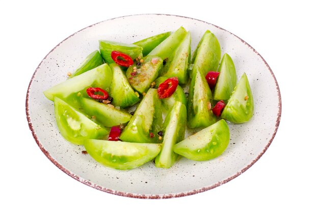 Appetizer of spicy pickled green tomatoes.