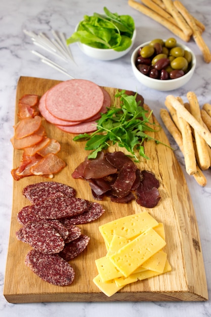 Photo appetizer table for wine or beer with sausages, dried meat and cheese