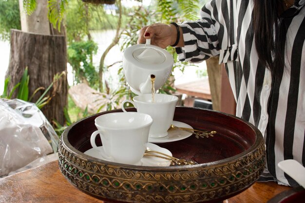 Appetizer and teapot cup set for tea time to travelers and\
guest in dining terrace outdoor of restaurant at resort hotel in\
thailand