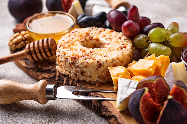 Appetizer for wine, cheese plate with grapes and figs