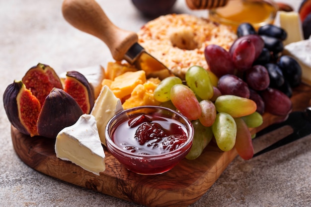 Appetizer for wine, cheese plate with grapes and figs