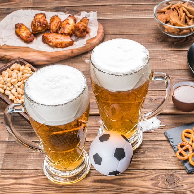 Appetizers and beer on the table for watch the football match.