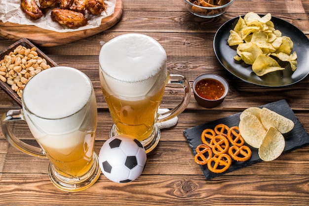 Appetizers and beer on the table for watch the football match.