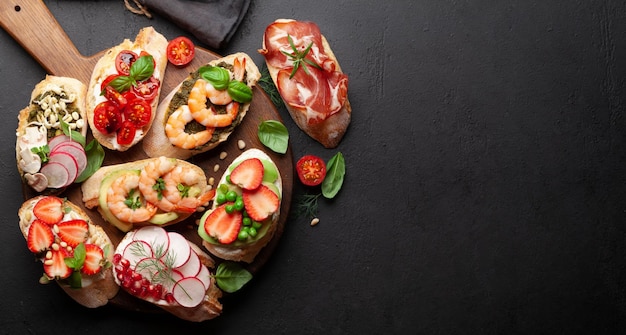 Appetizers board with traditional spanish tapas set Italian antipasti brushetta snacks