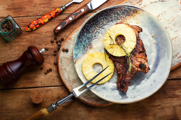 Appetizing beef meat baked with pineapple rings Beef entrecote in fruit marinade