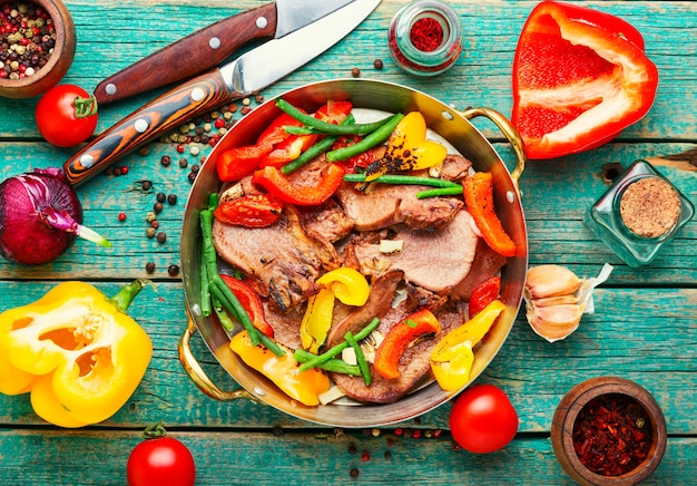 Appetizing boiled beef tongue with bell pepper