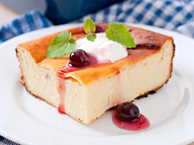 Appetizing cottage cheese casserole on white plate close up