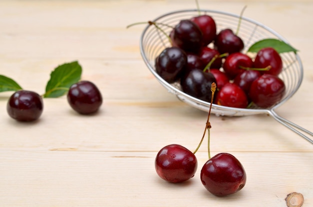 Appetizing dark red cherries on a wooden table