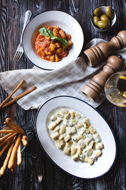 Appetizing dish on a dark wooden table. Dinner for two.