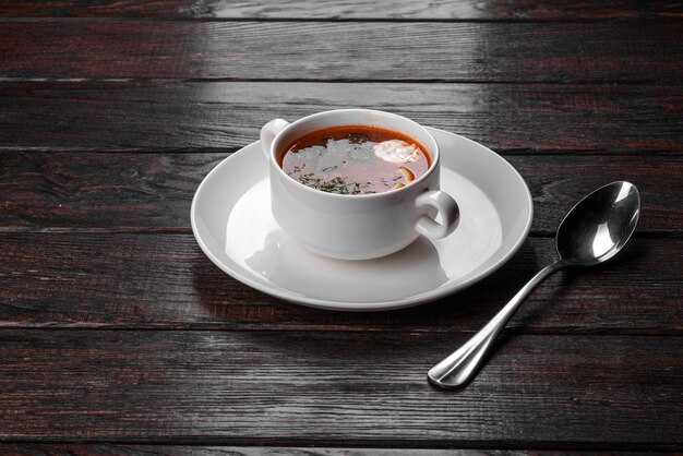 Appetizing dish of russian hodgepodge soup in ceramic pot