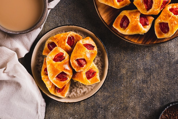 Appetizing envelopes with cheese and pepperoni sausage on a plate on the table top view