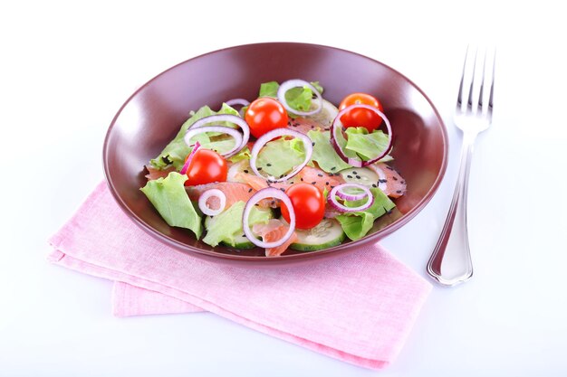 Appetizing fish salad with vegetables on plate isolated on white