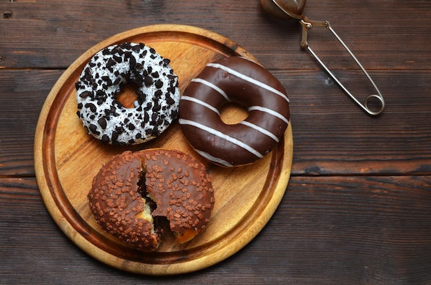 Appetizing frash donuts in glaze on a table