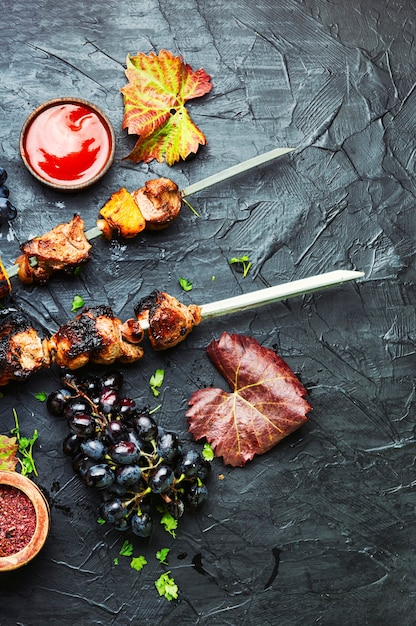 Appetizing fresh meat kebab in grape.Grilled meat skewers