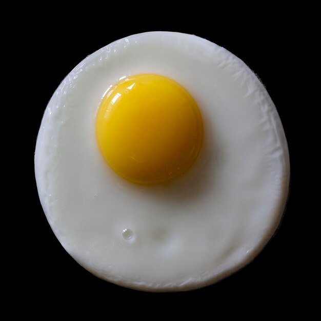 Appetizing fried egg on a black background top view