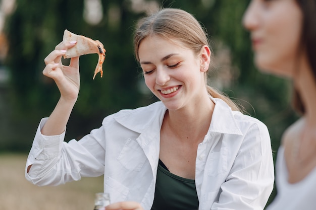 Appetizing girl eating pizza