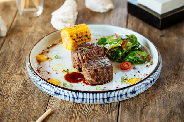 Appetizing grilled filet mignon steak with corn