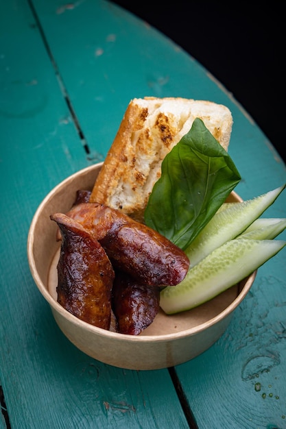 appetizing grilled sausages with sauce and bread