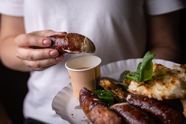 appetizing grilled sausages with sauce and bread