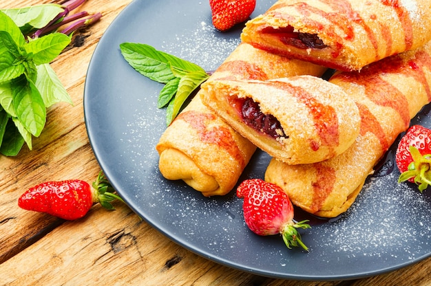 Appetizing homemade pies with strawberries and jam