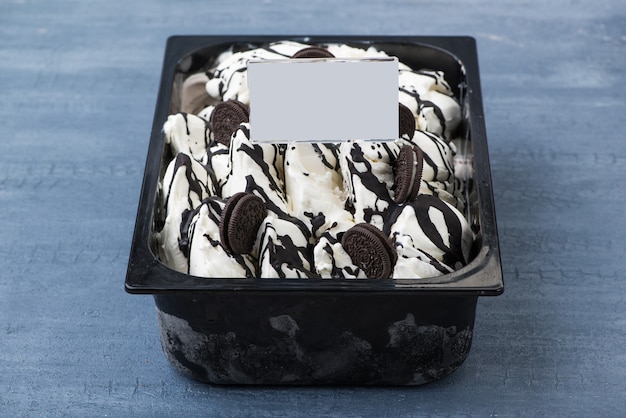 Appetizing ice cream in a plastic container with a price tag on a decorative blue background