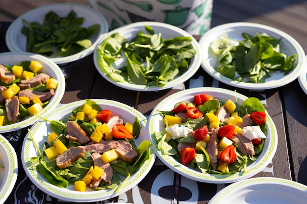 appetizing light salads with strawberries in plates on the table