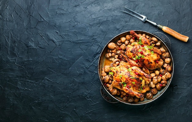 Appetizing little chicken or hen baked with mushrooms champignons