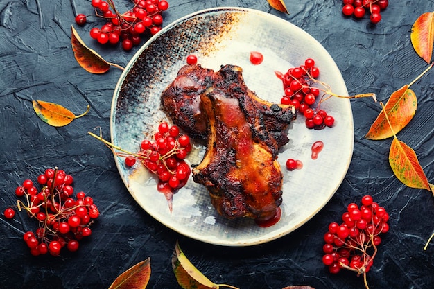 Appetizing meat on the bone grilled with viburnum syrup.