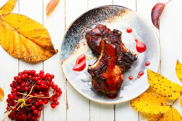 Appetizing meat on the bone grilled with viburnum syrup.