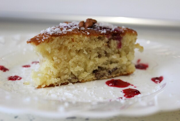 Appetizing piece of cake on a white plate closeup