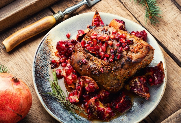 Appetizing piece of pork loin in a fruity marinade Fried meat with pomegranate