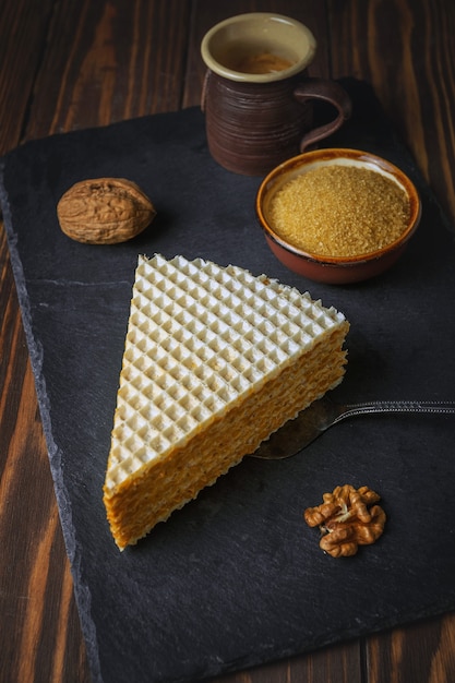 An appetizing piece of waffle cake and coffee cup. Close up view.