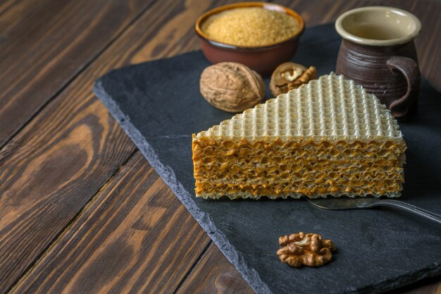 An appetizing piece of waffle cake and coffee cup. Close up view.