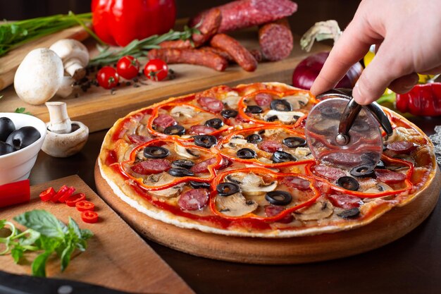 Appetizing pizza on a dark table with ingredients