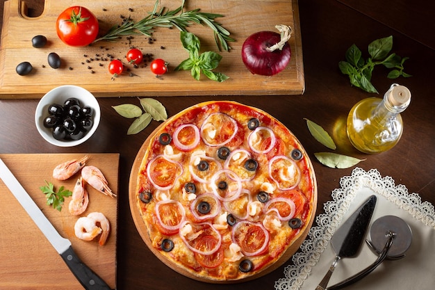 Appetizing pizza on a dark table with ingredients