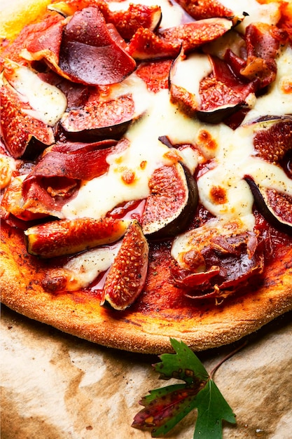 Appetizing pizza with bacon and fruit