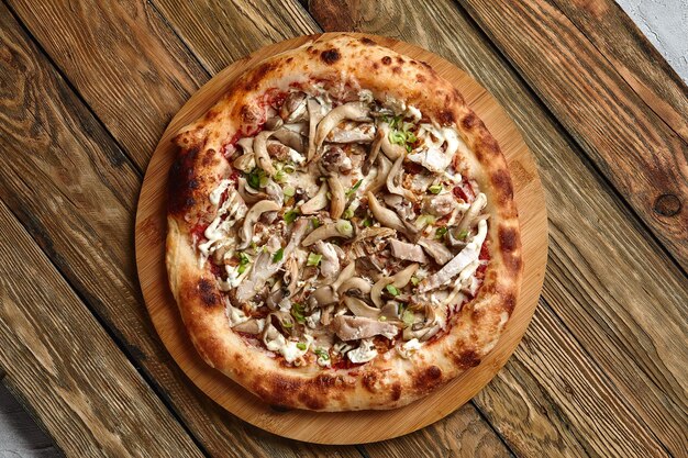 Appetizing pizza with mushrooms on a wooden tray