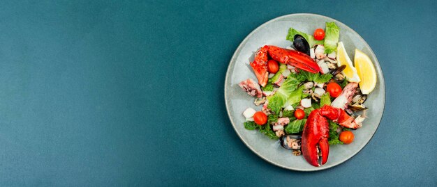 Appetizing salad of oysters mussels lobster and vegetables Ketogenic