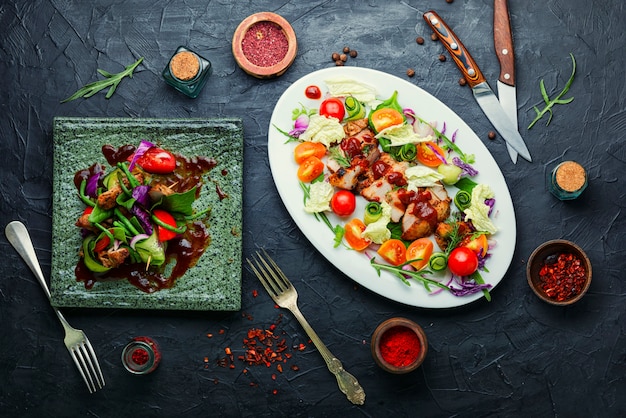 Appetizing salad with tomato,cucumber,lettuce and meat steak.Sliced grilled steak