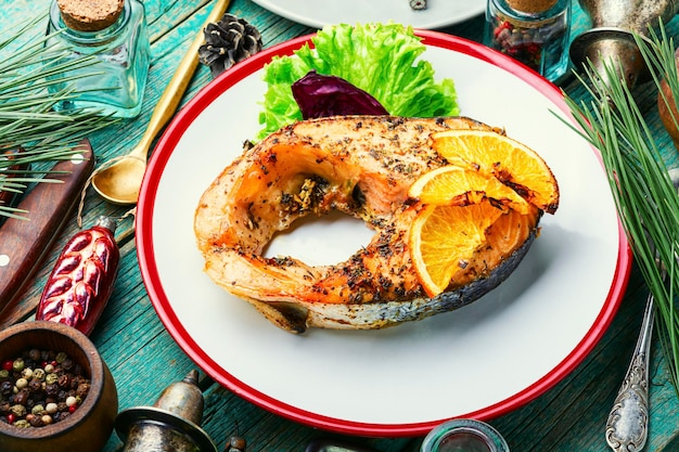 Appetizing salmon steak baked with oranges.Fish steak,Christmas food.