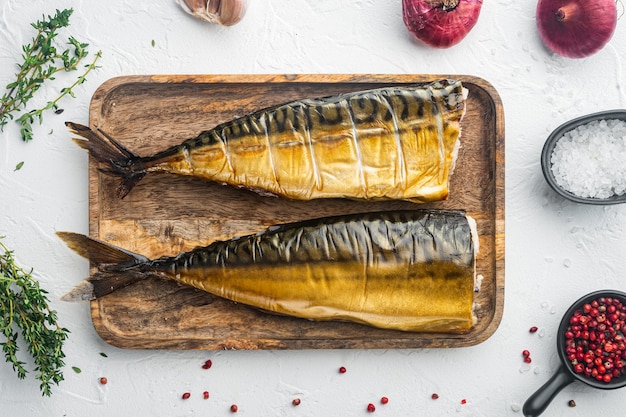 Appetizing smoked fish mackerel, on white background, top view flat lay