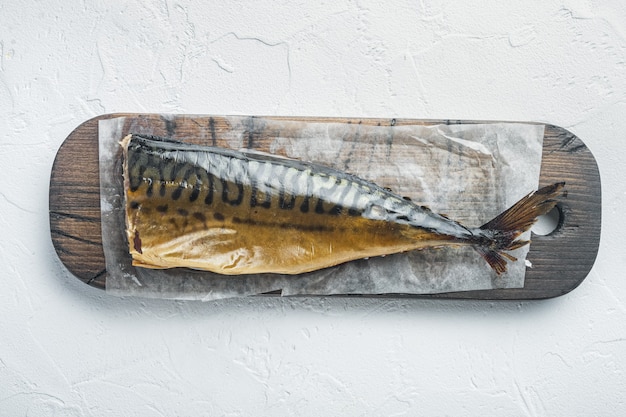 Appetizing smoked fish mackerel, on white background, top view flat lay