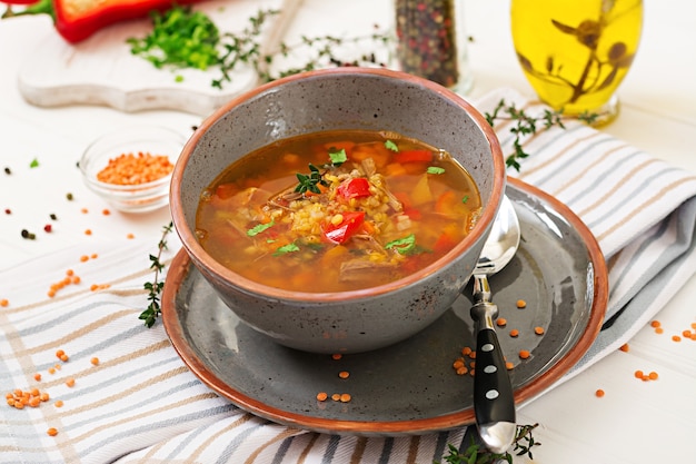 Appetizing soup with red lentils, meat, red paprika and fragrant thyme