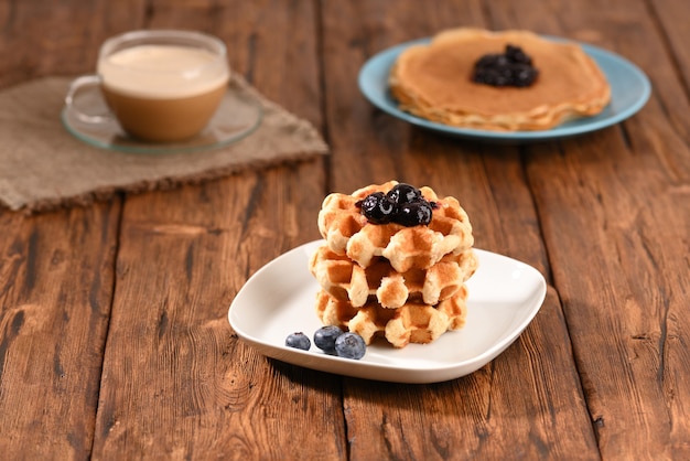 Appetizing waffles with jam for dessert