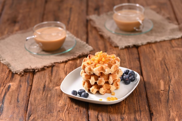 Appetizing waffles with jam for dessert.